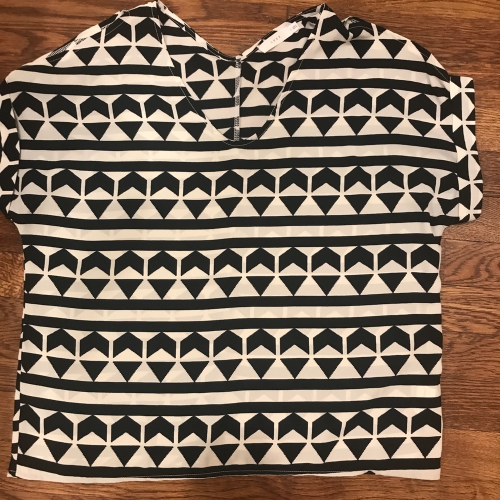 Black and white geometric top with sleeve cutouts.